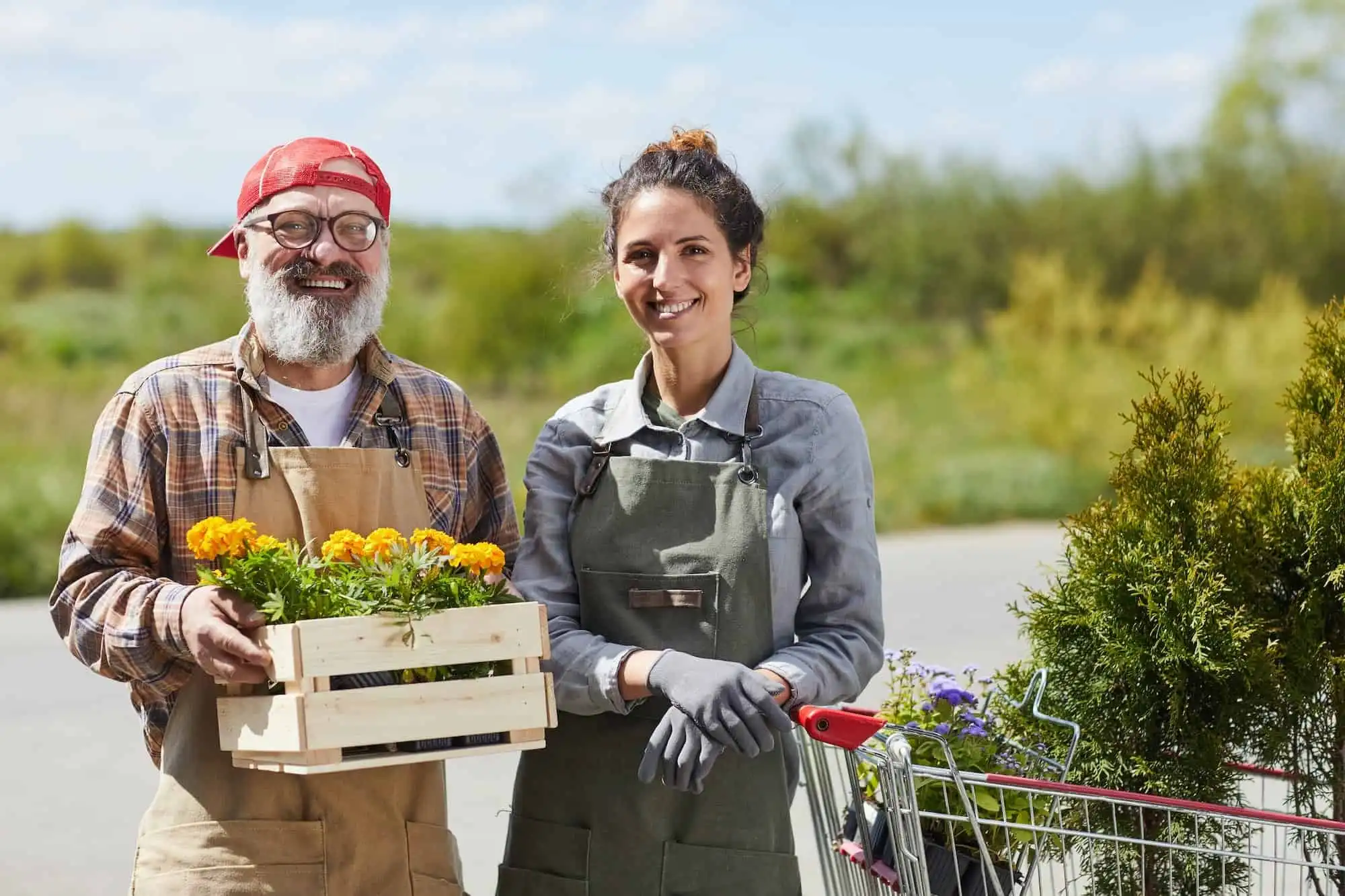 Farm couple holding a crate of fresh produce